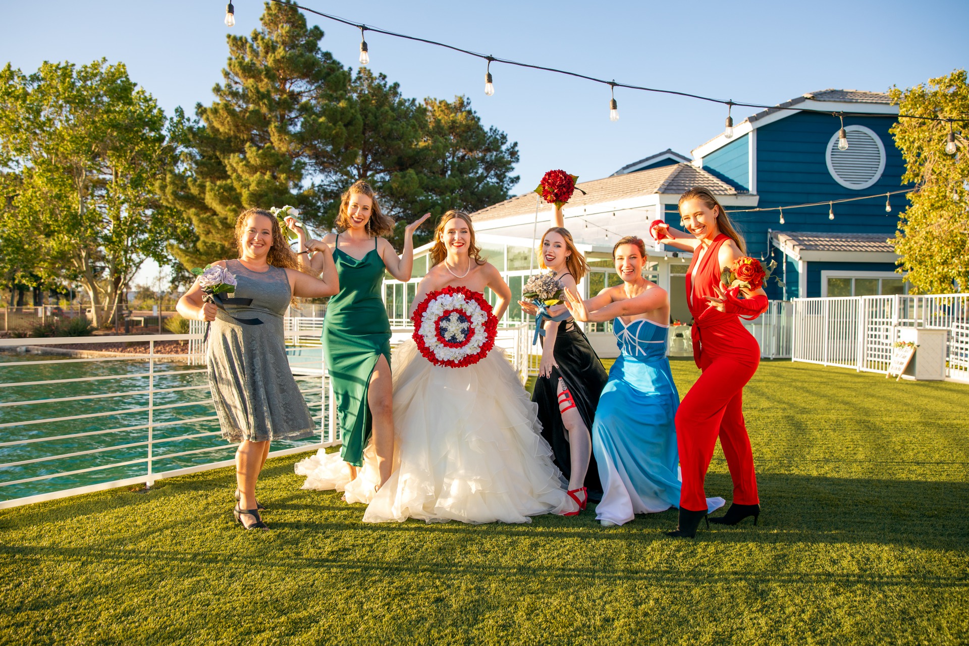 Bride and bridesmaids posing in their avengers inspired dresses. Comic book wedding inspiration