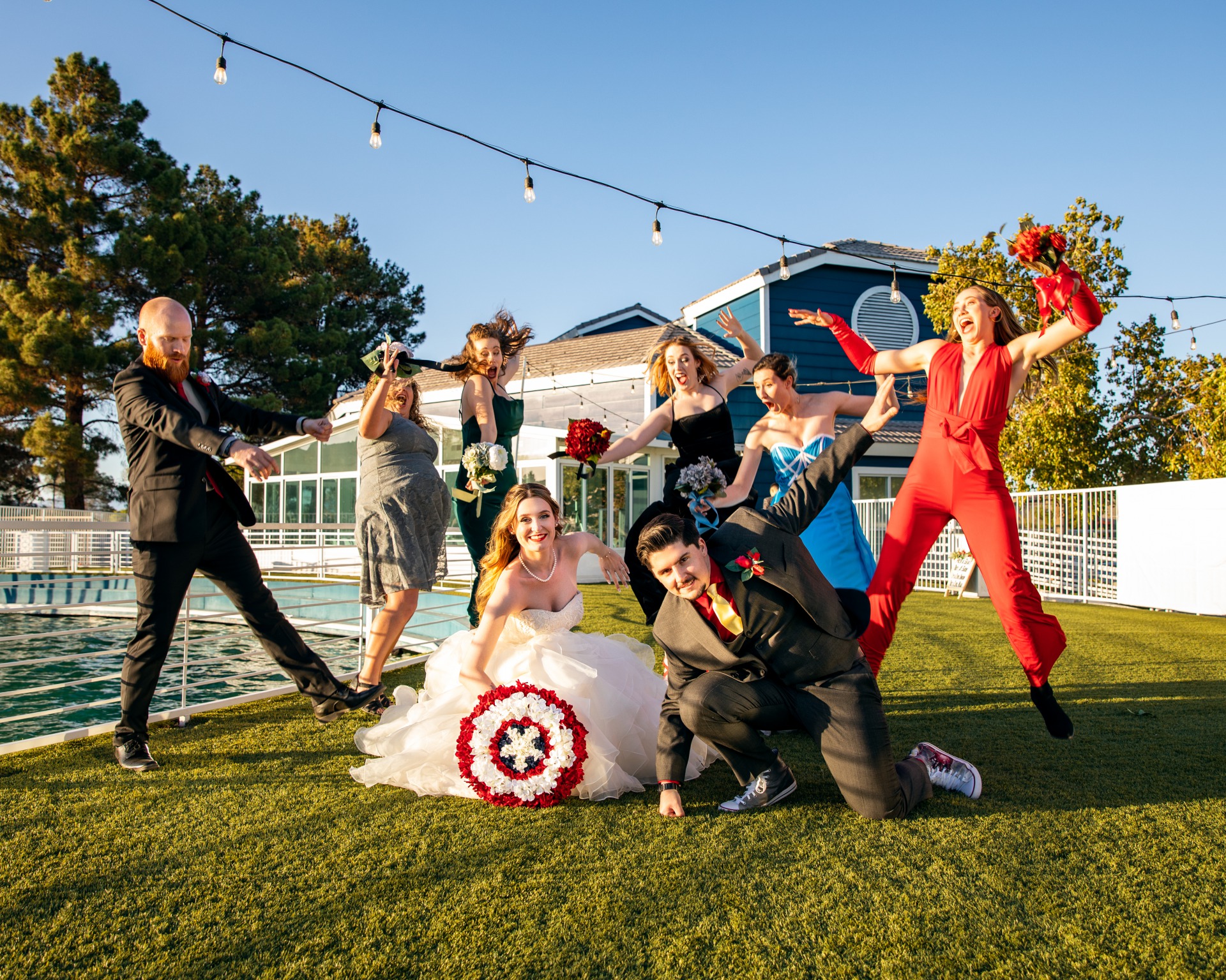 Couple has unique comic book wedding inspiration theme. Bride with captain america bouquet poses with goom and bridal party with Avengers inspired outfits.