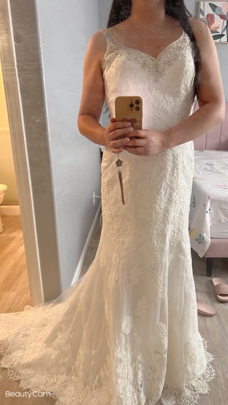 Bride takes selfie in her wedding dress before gown alterations