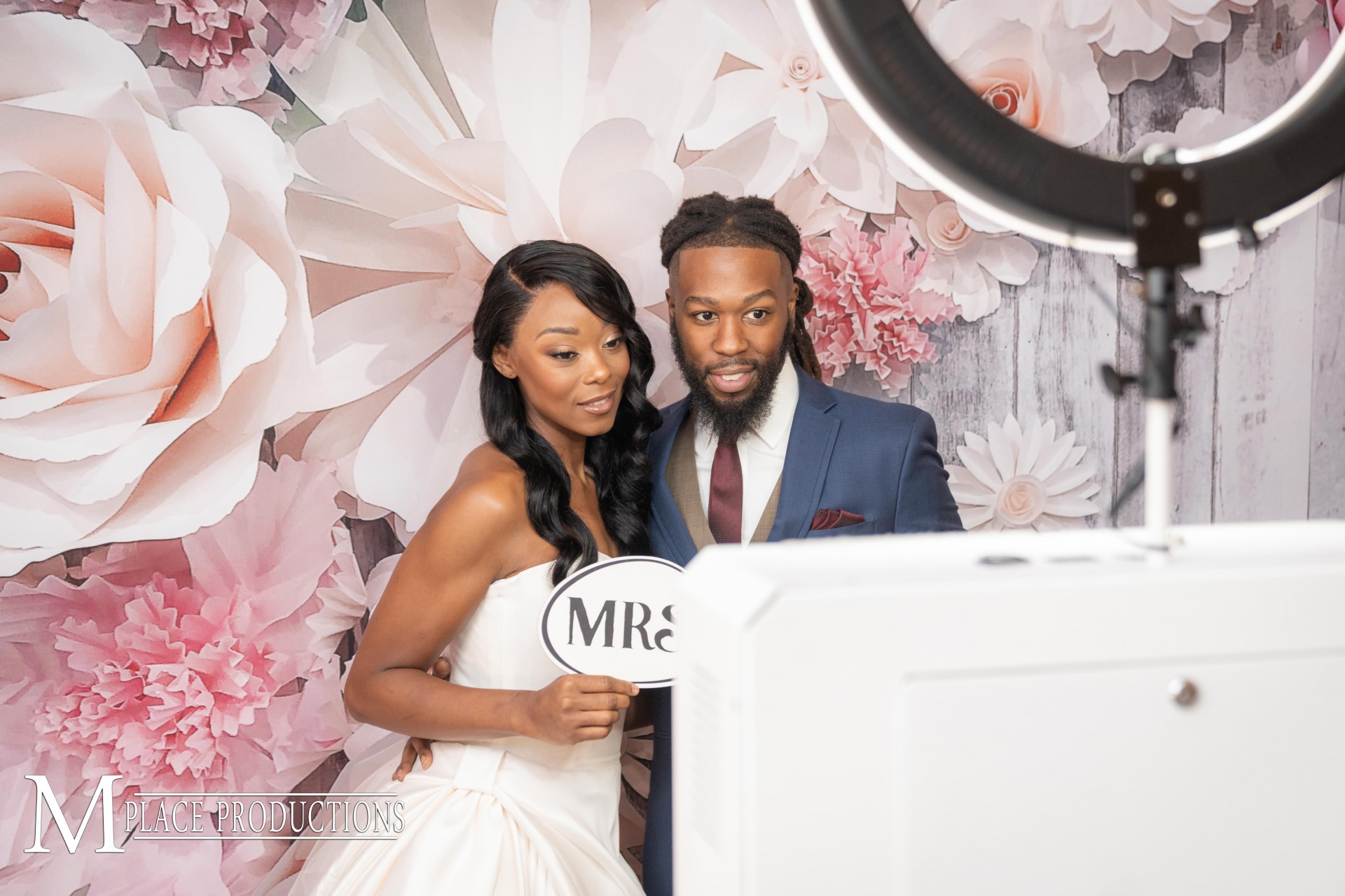 Couple uses the photo booth with pretty floral background from Knight Sounds entertainment, Las Vegas DJ Company. 