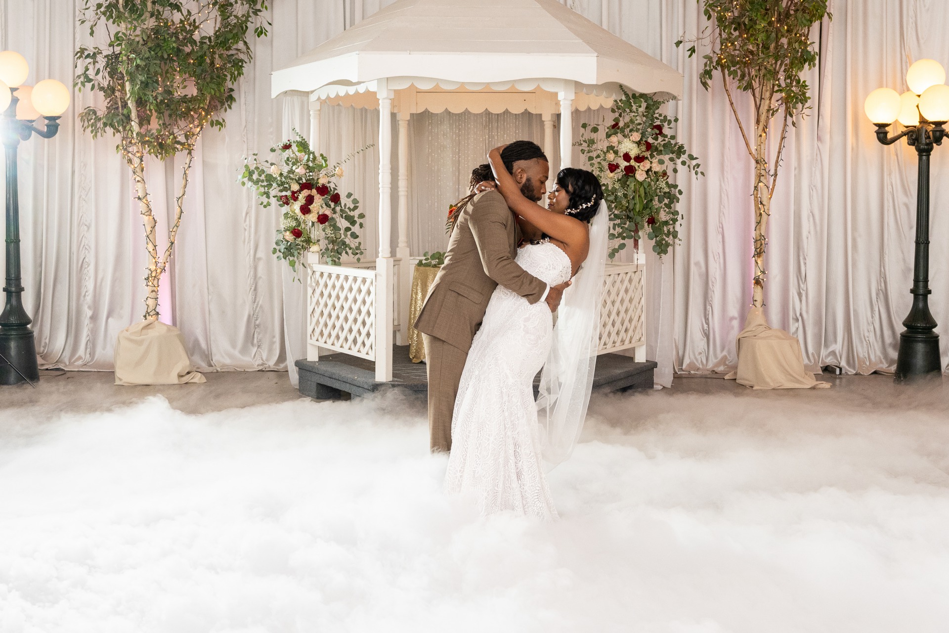 Groom dips his bride during first dance while the dance floor is covered in fog. Las Vegas DJ Company Knights sounds entertainment offers this fun feature.